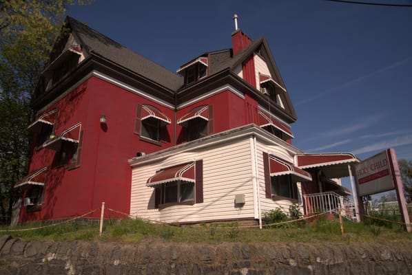 Exterior view of a red assisted living facility