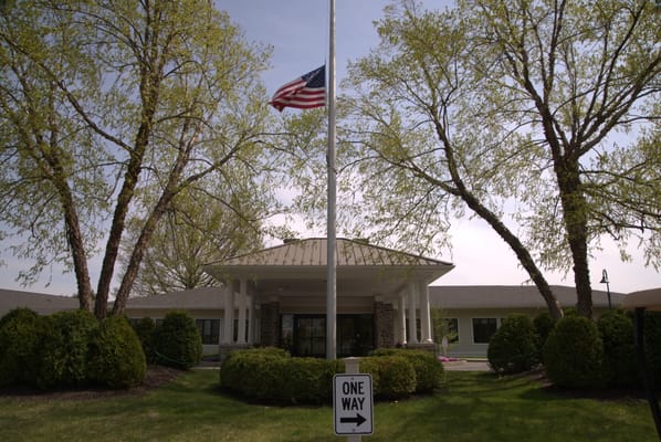 Main entrance of Beaumont At Bryn Mawr with flag and signage