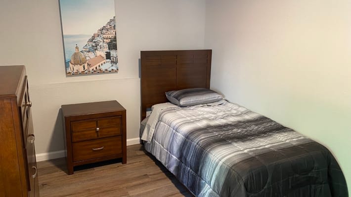 Cozy private room with a bed and dresser