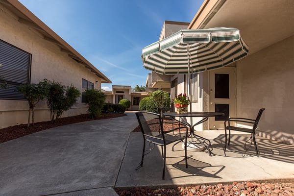 Outdoor seating area with a small table and umbrella
