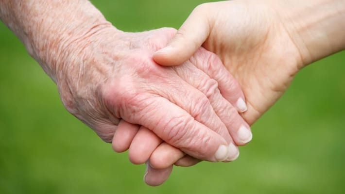 Two hands holding, symbolizing care and support