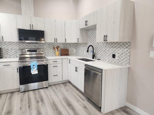 Modern kitchen featuring stainless steel appliances and light-colored cabinetry.