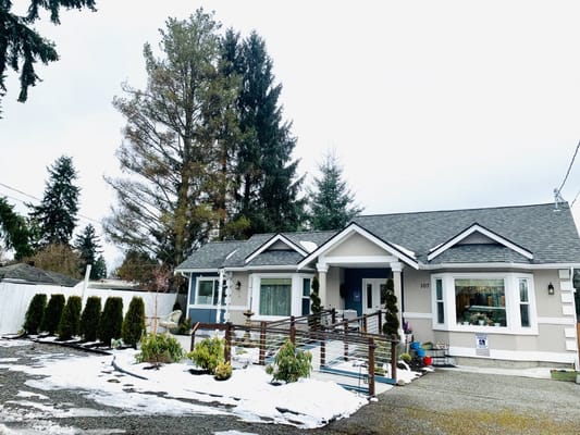 Exterior view of a senior care facility with greenery
