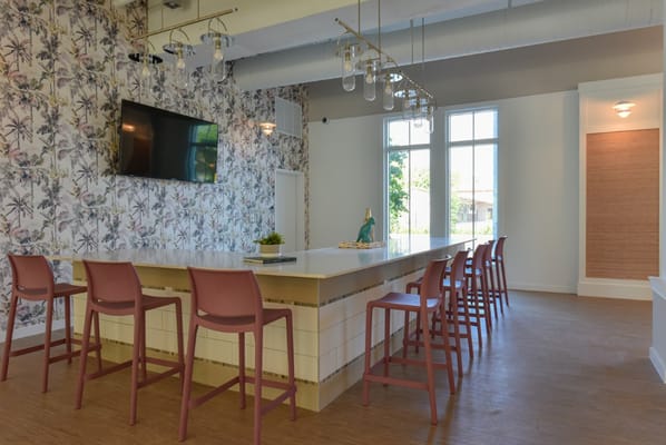 Bright common area with bar seating and floral wallpaper