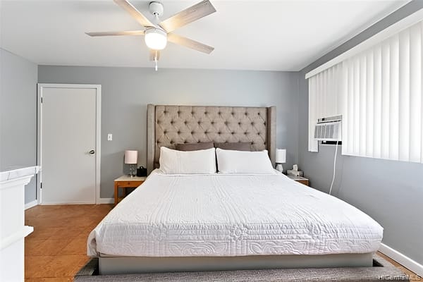 Stylish bedroom with a large bed and modern ceiling fan