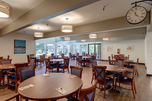 Dining room setup with wooden tables and blue chairs
