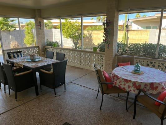 Outdoor seating area with tables and chairs