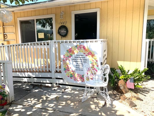 Outdoor area with a floral banner and white chair