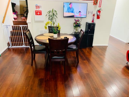 Common area with residents and a TV in the background