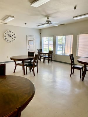 Bright common area with tables and chairs at Gettysburg Christian Home.