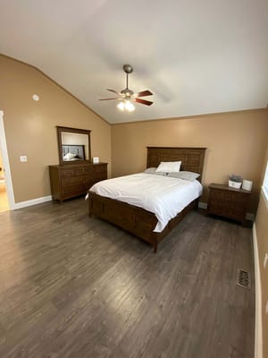 Interior view of a bedroom featuring a wooden bed and dressers