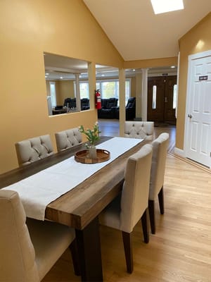 Dining area with a wooden table and beige chairs