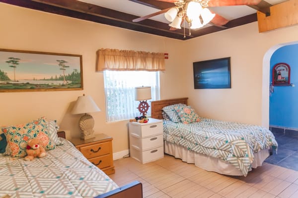 Cozy resident bedroom with two beds and decor