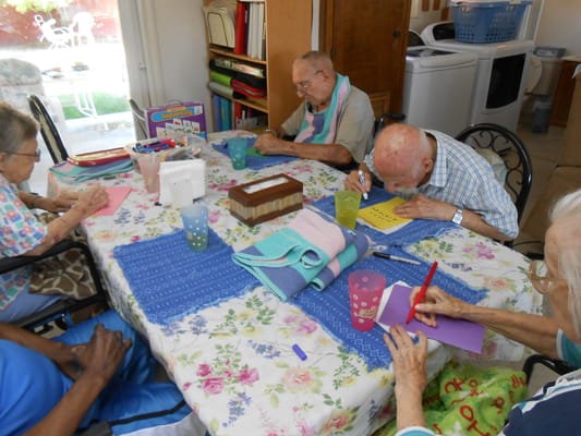 Residents engaged in a creative activity at a table