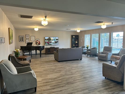Spacious living room with piano and seating area
