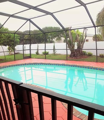 Outdoor pool area with a screened enclosure