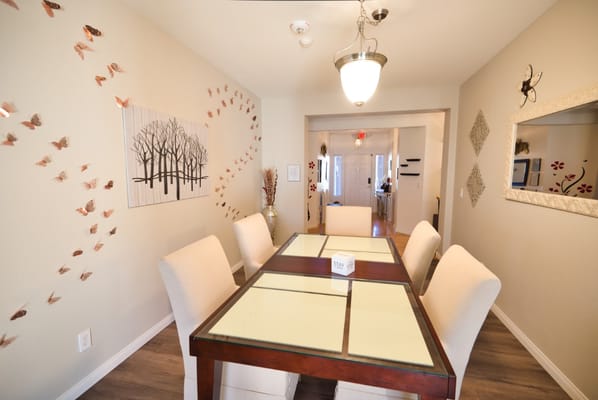 Bright dining area with decorative wall art