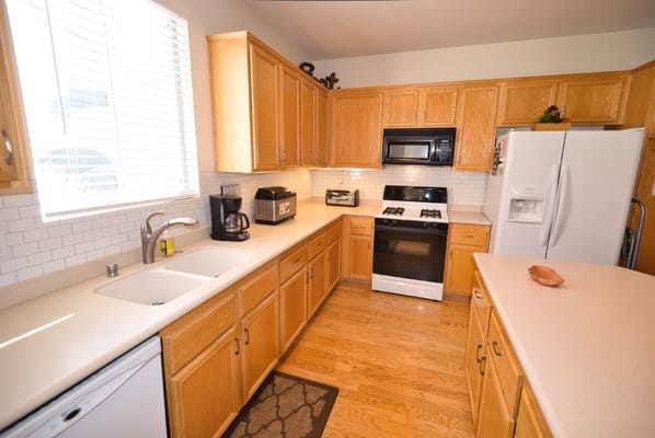 Bright kitchen with wooden cabinets and appliances