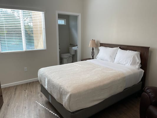 Well-furnished private resident room with bed and amenities