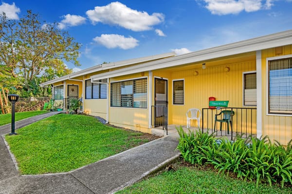 Exterior view of Haili Elderly Apartments with pathways and greenery