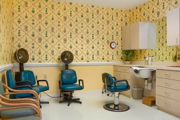 Hair salon area with styling chairs and cabinets