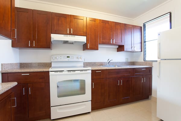 A bright kitchen with wooden cabinets and appliances