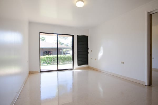 Empty room with large window and door