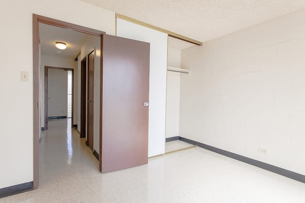 Empty room with a door leading to a hallway