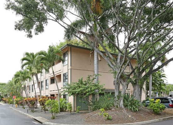 Exterior of Hale Mohalu Senior Apartments surrounded by greenery