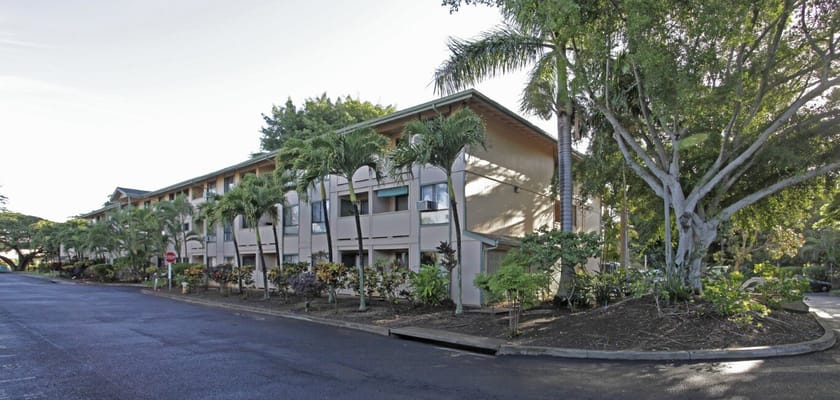 Exterior view of Hale Mohalu Senior Apartments surrounded by landscaping