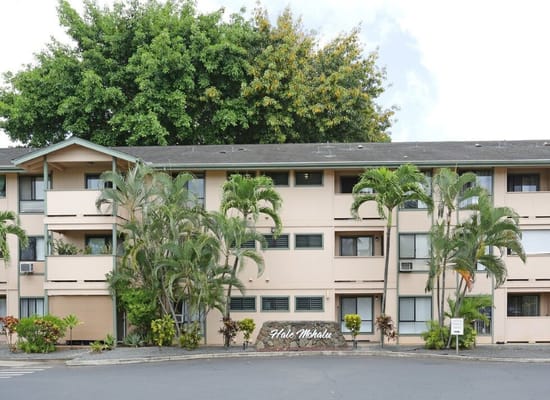 Facade of Hale Mohalu Senior Apartments with palm trees