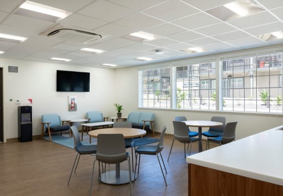 Bright common area with seating and large windows.