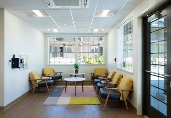 Lounge area featuring yellow chairs and a round coffee table.