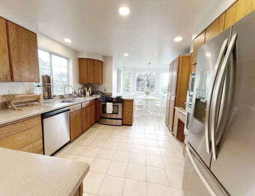 Bright kitchen area with wood cabinets and dining space
