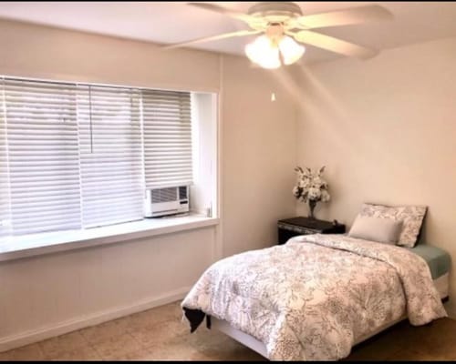 Cozy resident room with bed and window