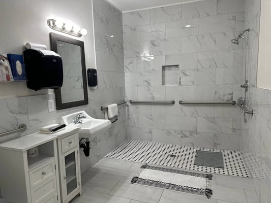 Brightly lit accessible bathroom with grab bars