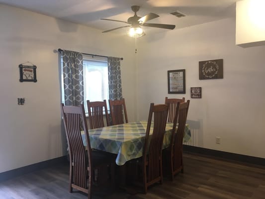 Dining area with large table and wooden chairs