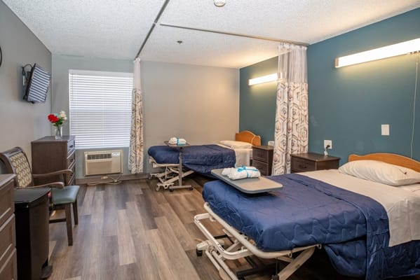 A shared resident room with two beds and modern furnishings