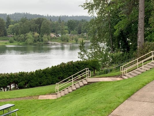 Green lawn with stairs leading to a lakeview