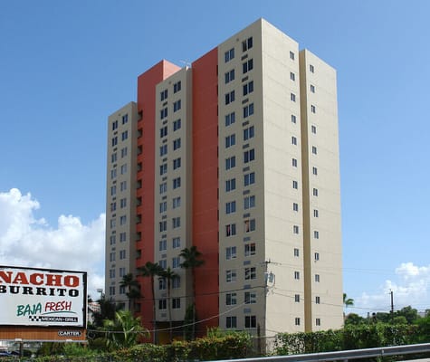 Tall residential building with orange and beige facade