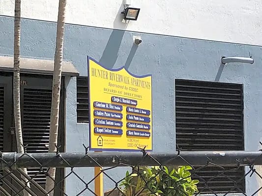 Sign displaying board of directors for Hunter River Walk Apartments