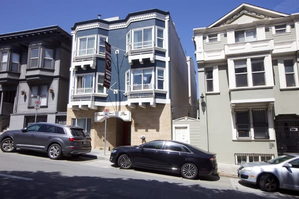 Exterior view of the facility building with parked vehicles