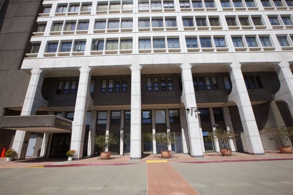 Main entrance of The Sequoias San Francisco featuring potted plants.