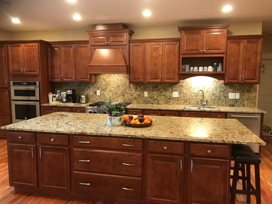 A well-designed kitchen with wooden cabinets and granite countertops