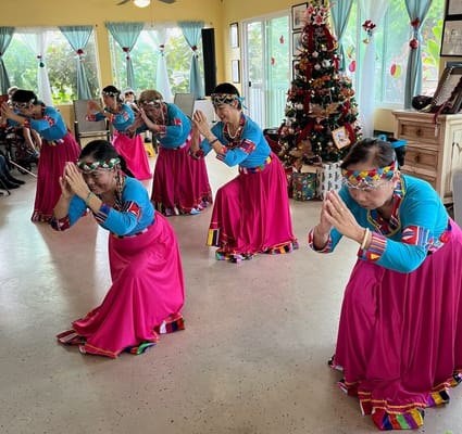 Residents performing a traditional dance in a festive interior