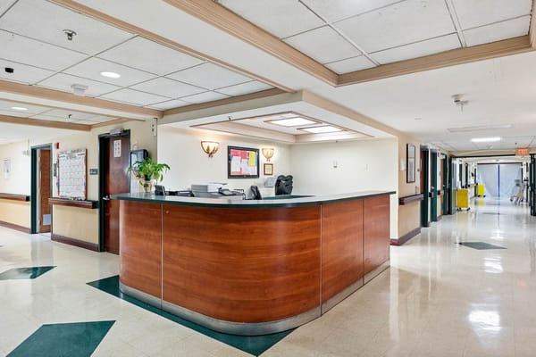 Wide shot of the reception area with a desk and hallway