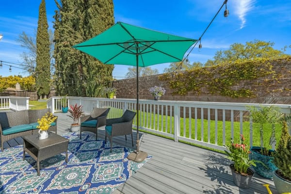 Outdoor seating area with umbrella and plants
