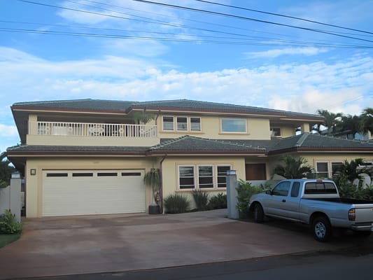 Exterior view of Kaimuki Care Home with vehicles
