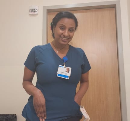 Staff member smiling in a facility room