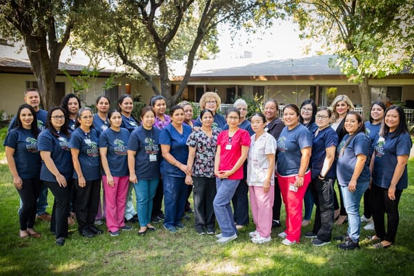 Staff members posing together in an outdoor area